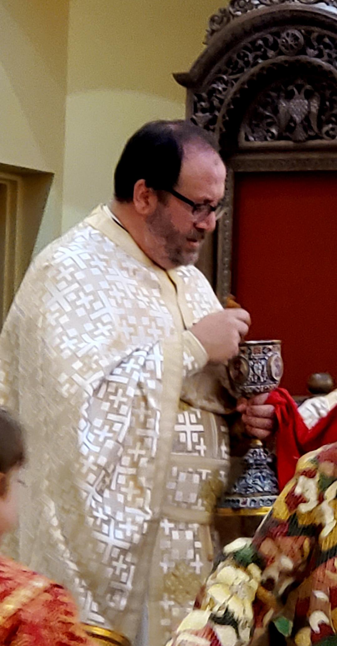 Priest giving communion